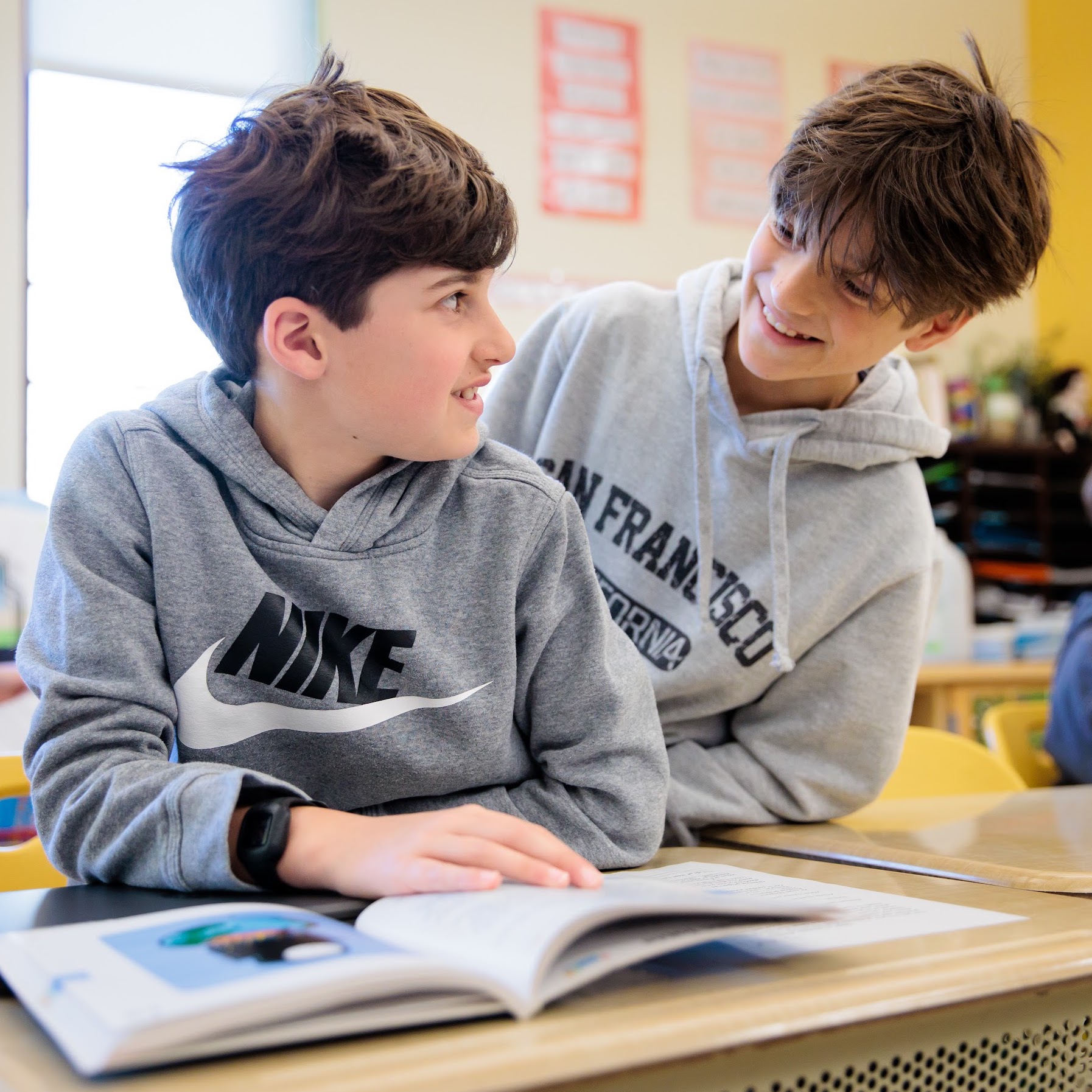 Two elementary school students have fun during a classroom assignment