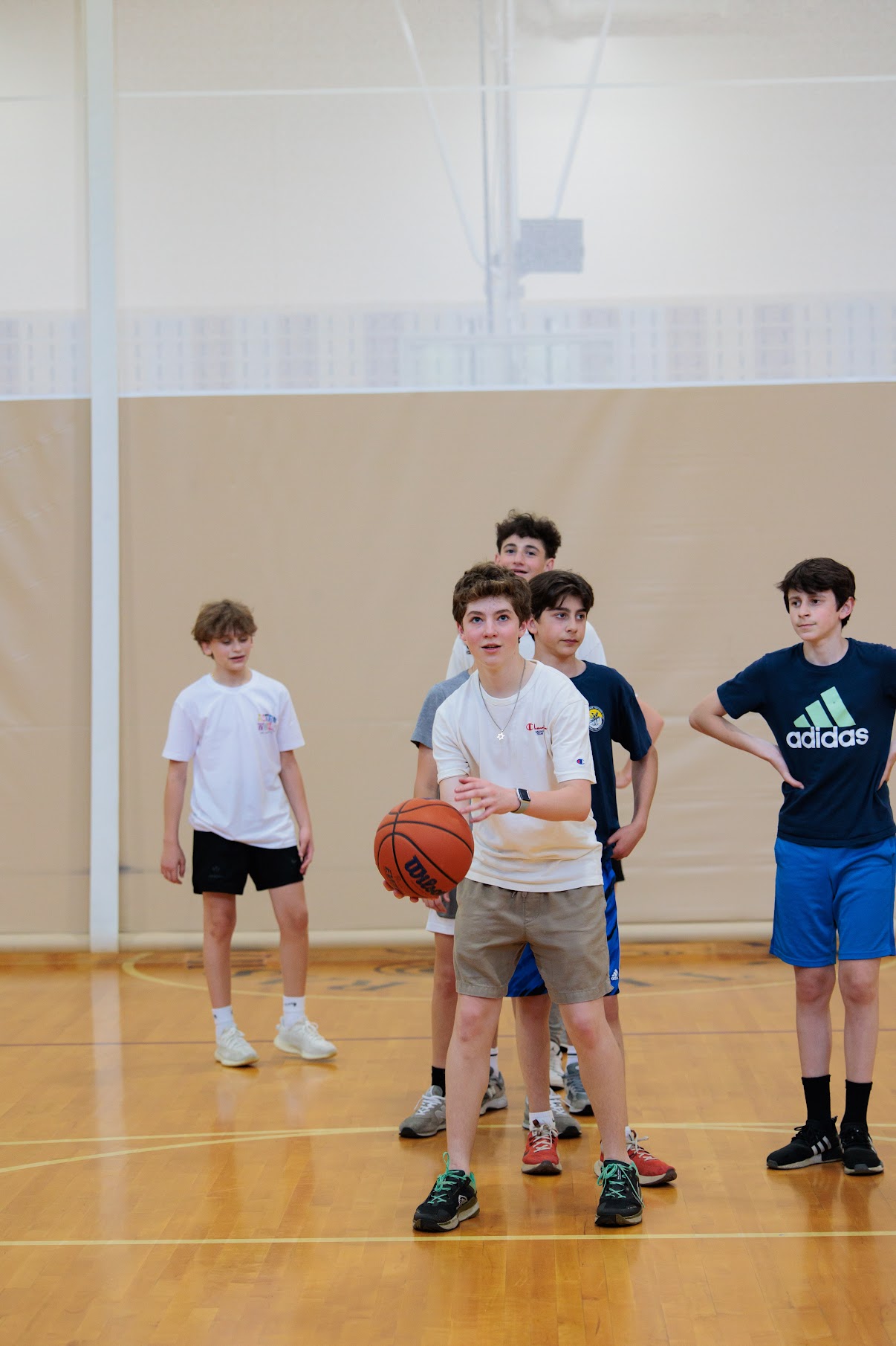 Middle school student plays basketball during fitness and health class